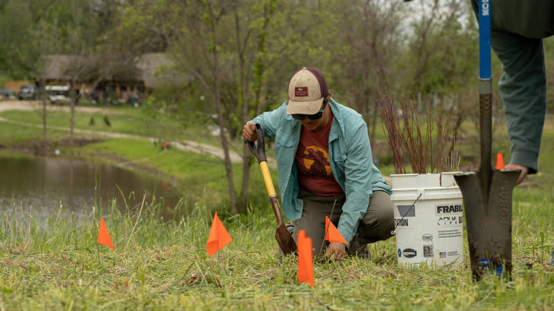 Worker in field with bucket