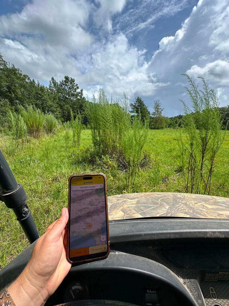 Map on phone in hand in vehicle in field